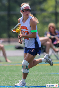 Lexi Ledoyen, #23 Capital Club Lacrosse, carries the ball in the midfield with an injury on her left knee at the Nike Elite G8 girls lacrosse tournament (2015).  The green band on Lexi's left arm shows she has committed to Syracuse as an early recruit.