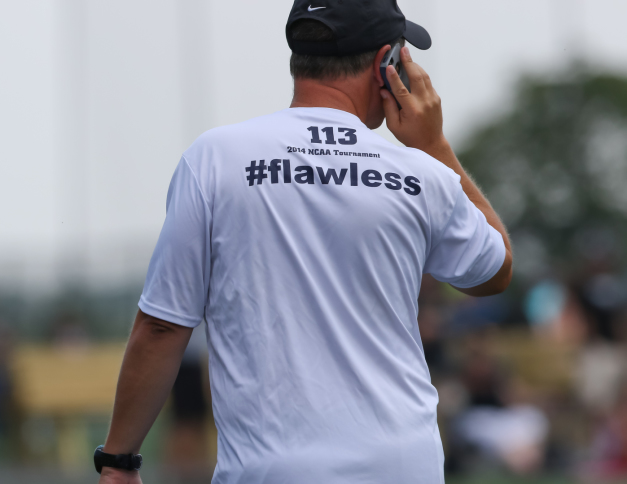 Georgetown women's lacrosse head coach speak on cell phone at early recruiting tournament with #flawless on back of t-shirt © Equity IX - SportsOgram - Leigh Ernst Friestedt