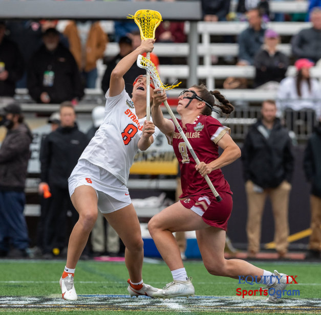 #8 Charlotte North (Boston College) draws against Syracuse center #8 at 2021 NCAA Women's Lacrosse Championship Game - yellow lacrosse ball is released from the head of lacrosse stick © Equity IX - SportsOgram - Leigh Ernst Friestedt