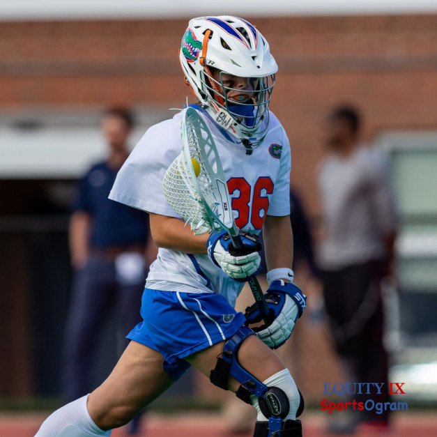 #36 Florida women's lacrosse goalie runs down the field carrying yellow lacrosse ball in an oversized lacrosse stick wearing a helmet with Florida gator at Big East Women's Lacrosse Championship Game © Equity IX - SportsOgram - Leigh Ernst Friestedt